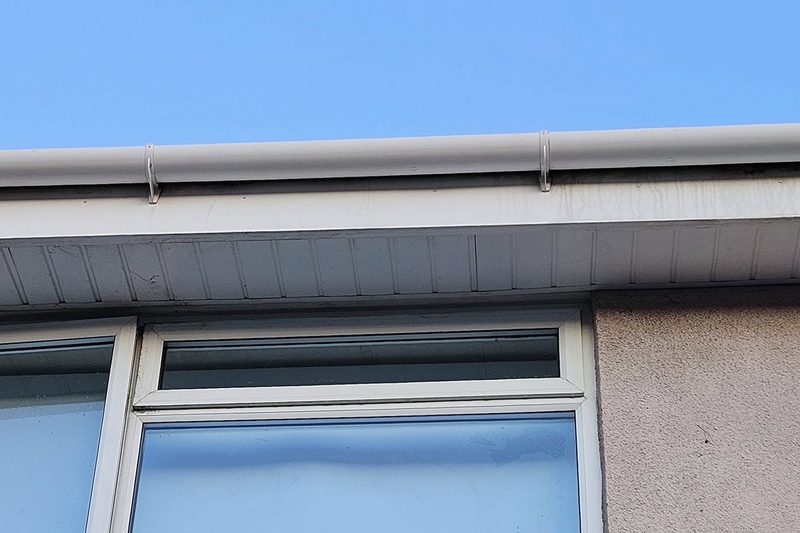 The same guttering and soffits cleaned back to white plastic.